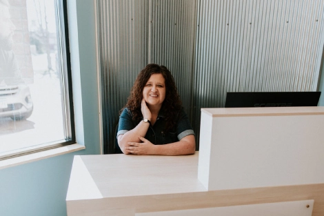 Stacy, the owner of Lotus Laser Aesthetics, at the front desk ready to welcome clients for personalized skin treatments.